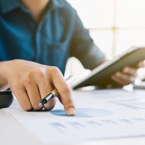 a man holding a clipboard looking at finances