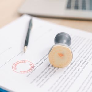 approved stamp over paperwork